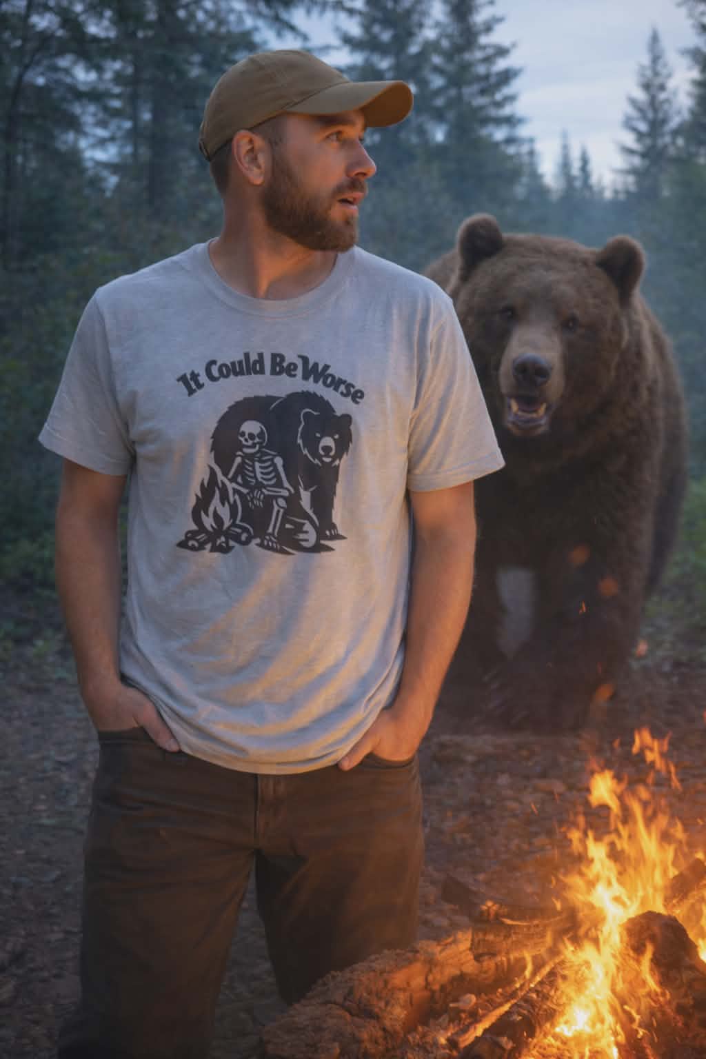 Man wearing a t-shirt with a bear graphic and text, standing next to a bear in a forest setting.